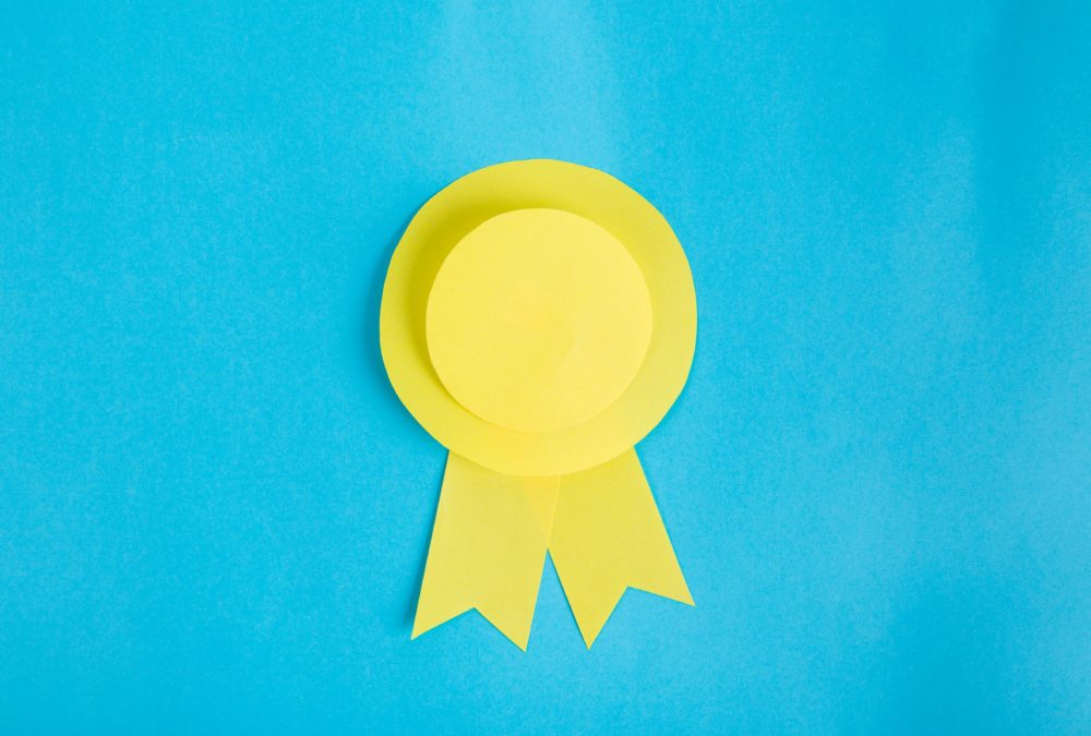 Yellow paper rosette on blue background